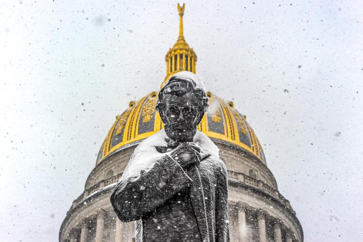 Lincoln Statue covered in snow with Capitol dome in the background